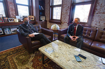 Creighton President the Rev. Daniel S. Hendrickson, SJ, PhD, (left) discusses the Arrupe Global Scholars and Partnerships Program with Creighton Board of Trustees chairman Mike McCarthy.
