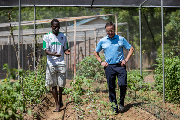 Dominic, owner of Kakuma Social AgriVentures, tells Fr. Hendrickson about his greenhouse business.
