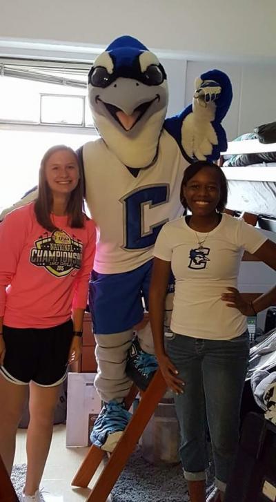 Billy Bluejay poses with two students inside Kiewit Hall