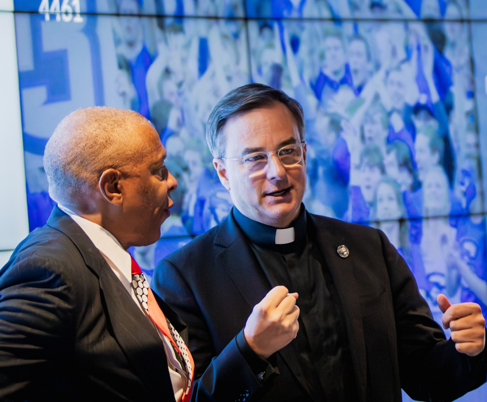 Mayor Ewing and Father Hendrickson speak at the Fly Together event