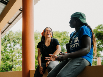 Two students speak at the ILAC campus in the DR.