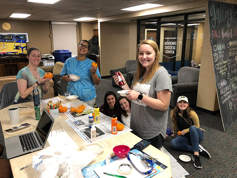 Friends make Halloween decorations in Gallagher.