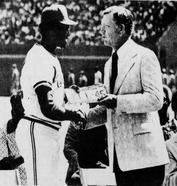Gov. Exon present Gibson with an "STL 45" Nebraska license plate in 1975. We can't be certain, but it appears to be a custom Creighton plate.