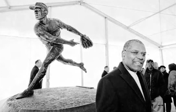 Gibson in front of his statue at Werner Park in 2013.