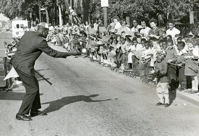 During the parade, Gibson stops to toss a ball to a boy who came with a catcher's mitt and mask. OMAHA WORLD-HERALD