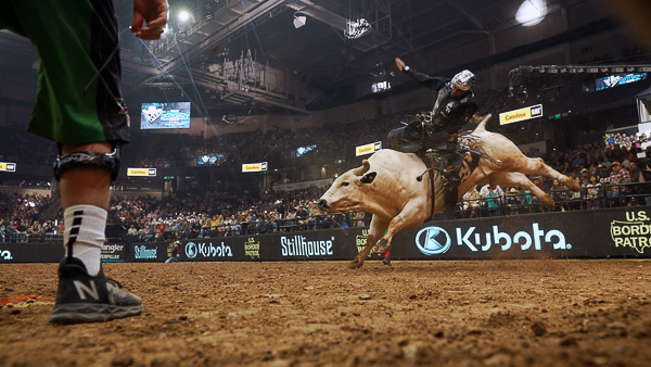 Image of a man riding a bull.
