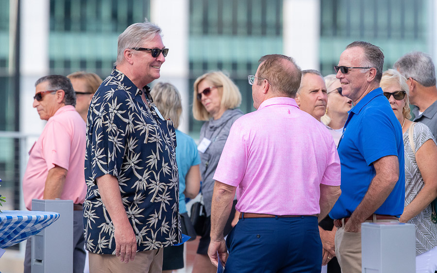 Guests talk at the Graves Hall dedication ceremony.