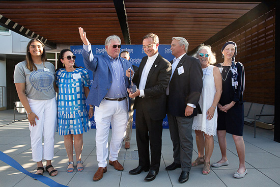 DSH, the Simpson and the Graves families cut the Graves Hall dedication ribbon.