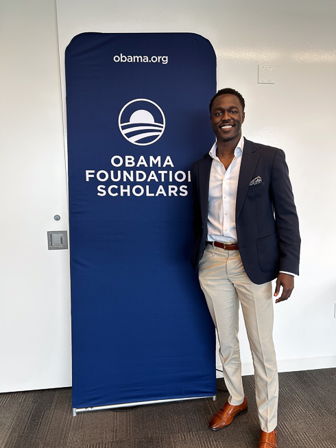 Jacob Idra in front of the Obama Foundation Scholars sign