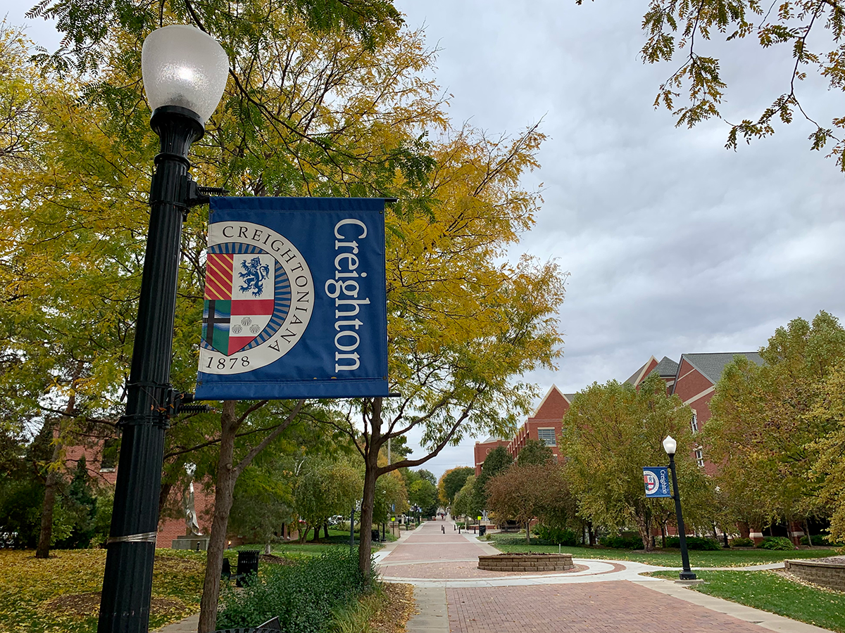 fall foliage by the arch and Opus Hall