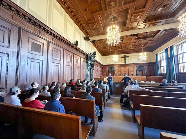 Students and faculty in the World Court's Courtroom 600, site of the 1945-46 Nuremberg International Military Tribunal.