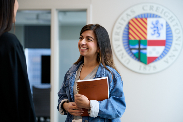 A student speaks with a Creighton staff member in the Success Center.