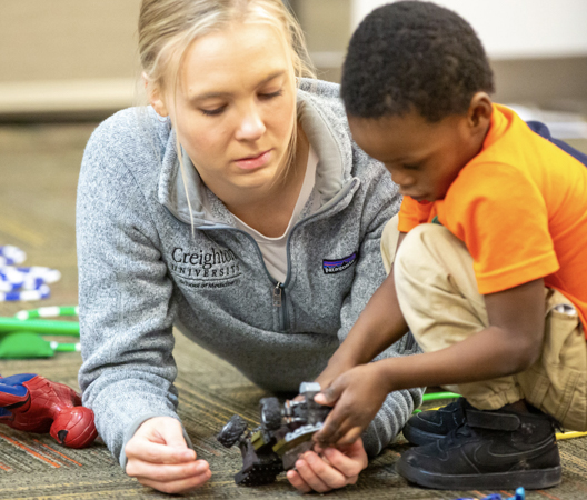 SOM student working with child.