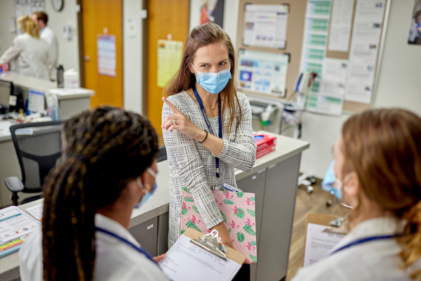 Sara Beste speaks with Creighton medical students at the Virginia G. Piper Charitable Trust Medical Clinic.