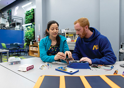 Two students work on tech in the Radlab.