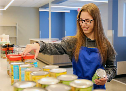 A student in the LIFT program working at the Blue Valley Food Pantry.