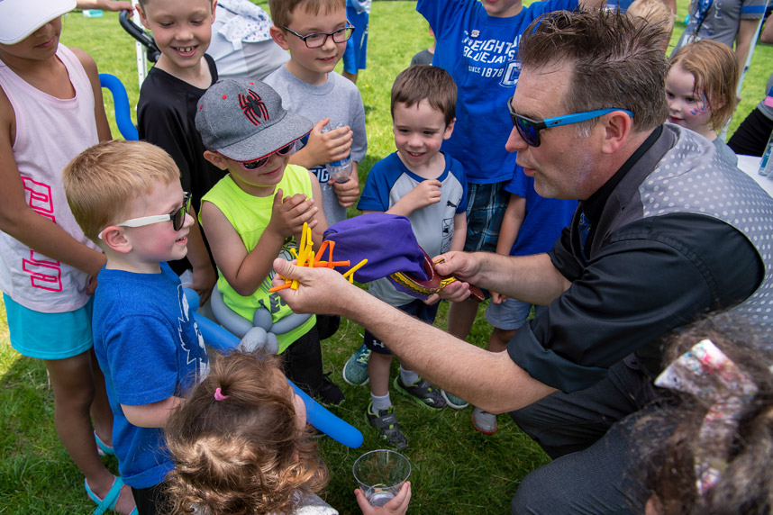 reunion weekend image 2 Creighton University reunion weekend man making balloon animals for children