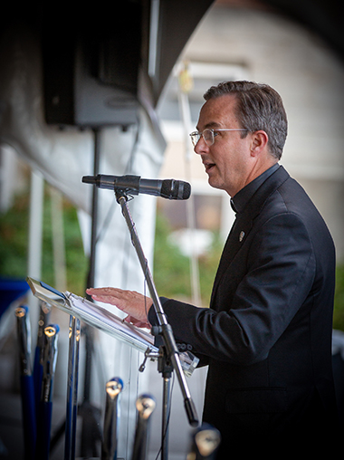 Fr. Hendrickson speaks at the ceremonial groundbreaking of the Jesuit Residence