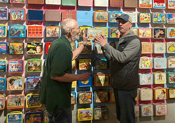 Michael, left, and Mark Kelehan complete the exhibit wall.