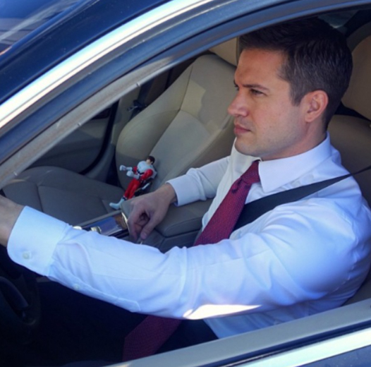 Dan Slavin drives with action figure.