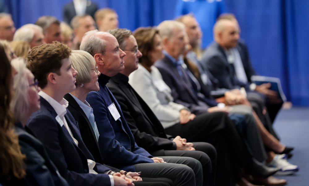 The Heider family and Father Hendrickson at the Sports Performance Center event.