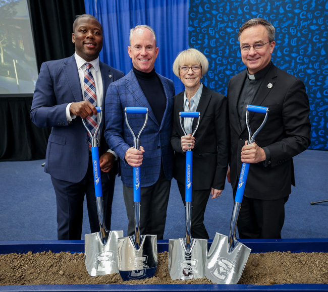 Marcus Blossom, Fly Together lead donors Scott and Cindy Heider, and Father Hendrickson.