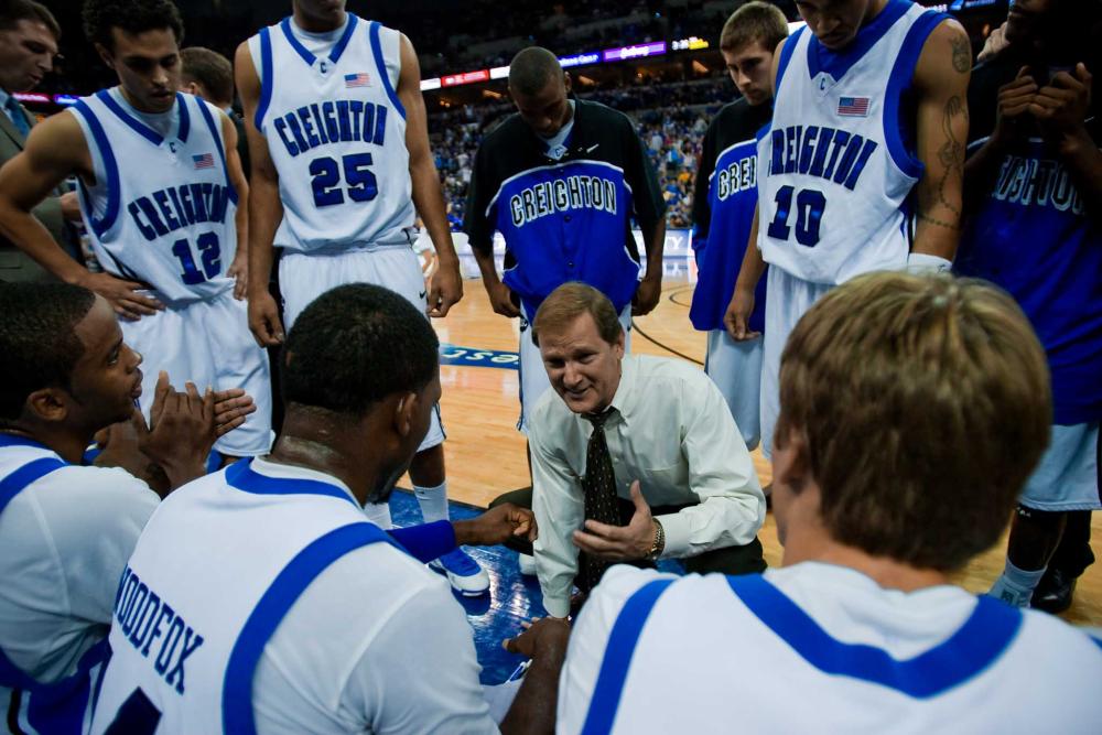A basketball coach talks to his team