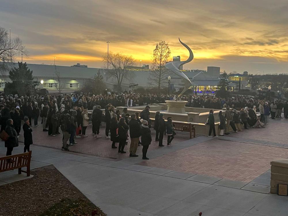 Students gather at the fountain to celebrate the lighting of campus