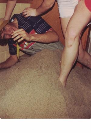 A photo of a pile of sand inside a Kiewit Hall dorm room