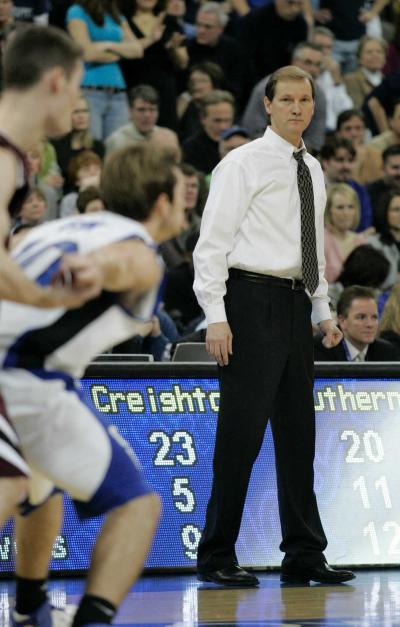 A basketball coach on the sideline during a game