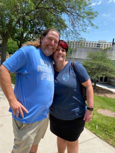 A man and a woman pose together for a photo