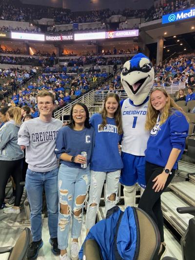 Four friends pose for a photo with Creighton's mascot