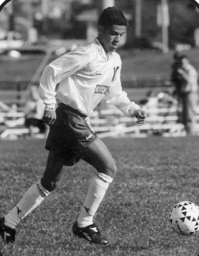 A soccer player dribbles down the field