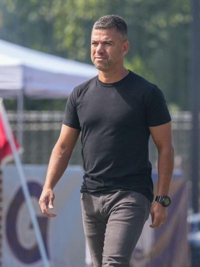 A soccer coach walking