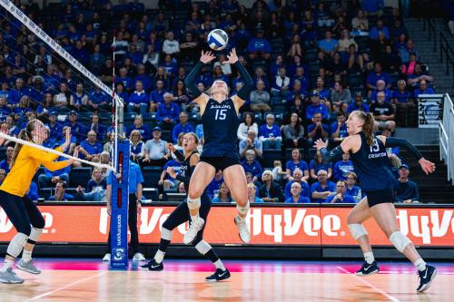 A volleyball player sets the ball