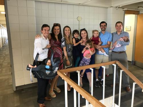 Several former Kiewit Hall residents and their families pose together for a photo