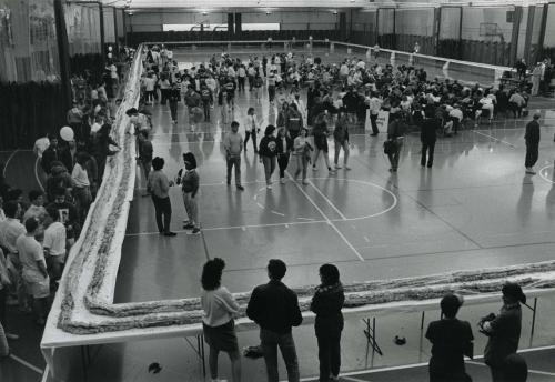 A long sandwich on tables in a gym
