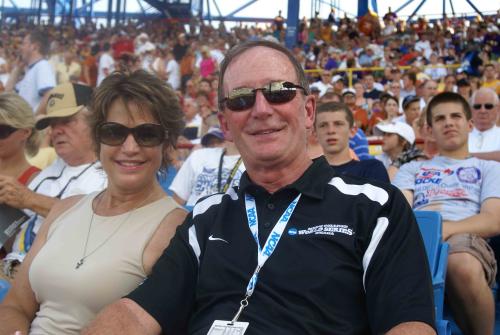 A couple at a baseball game poses for a photo