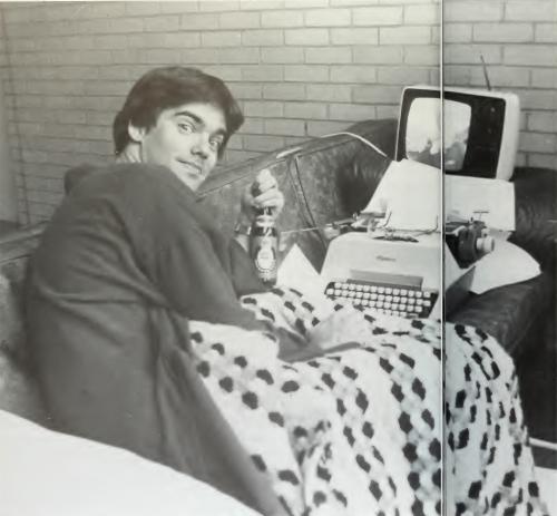 Creighton student studies in a Kiewit Hall common area in 1983