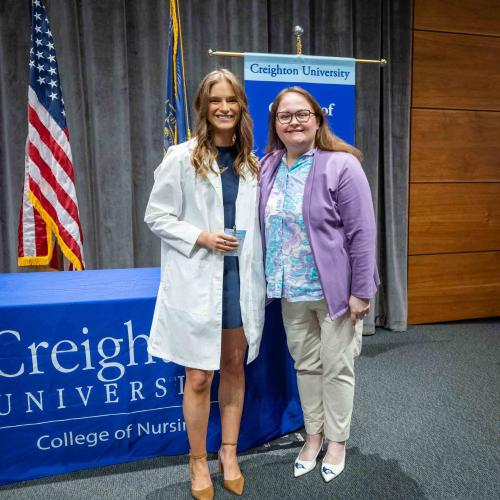 A student poses with a dean