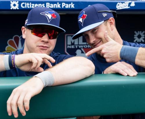 Two baseball players in the dugout