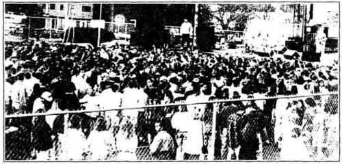 Students gather on a field for a concert