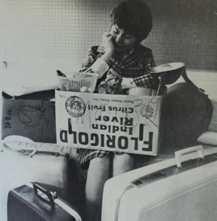 Student examines a move-in box in 1966