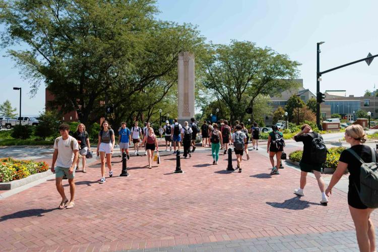 Students walk across a pedestrian crosswalk