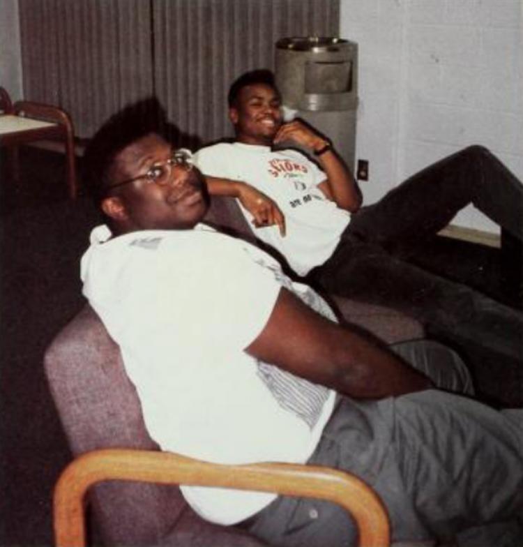 Two students lounging in Kiewit Hall in 1992