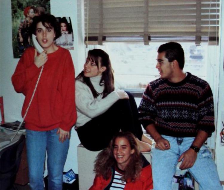 One student talks on the phone while her friends look on