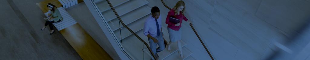 Students walk down the stairs.