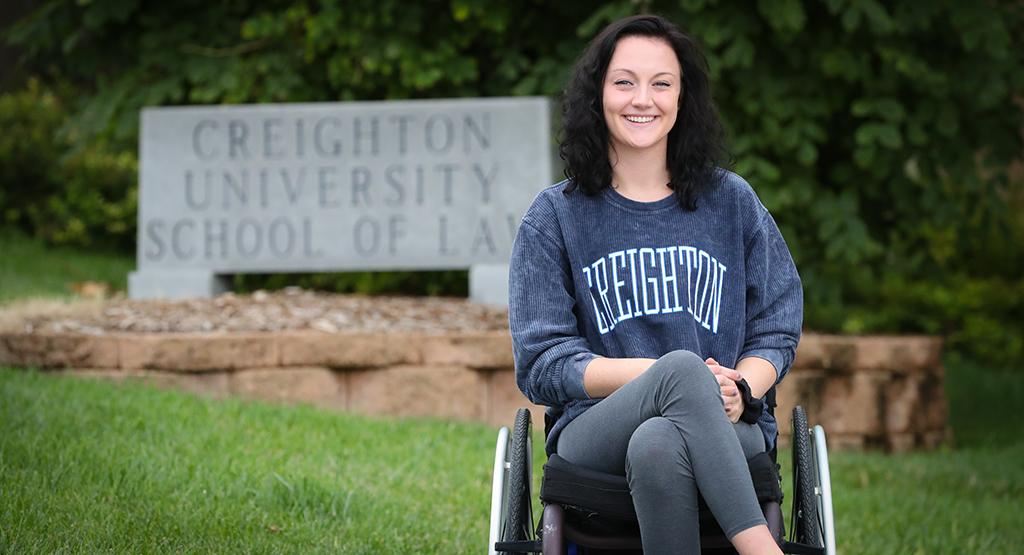 Student Lexi Weisbeck posting in front of Creighton