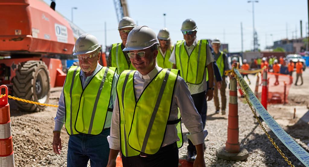 CL Werner and Fr. Hendrickson walking into the Werner Center construction site.