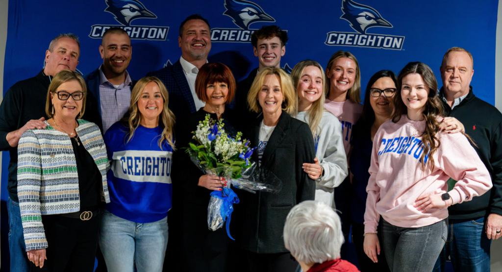 Patty Galas joins her family for a photograph at a March 1 Creighton men's basketball luncheon.